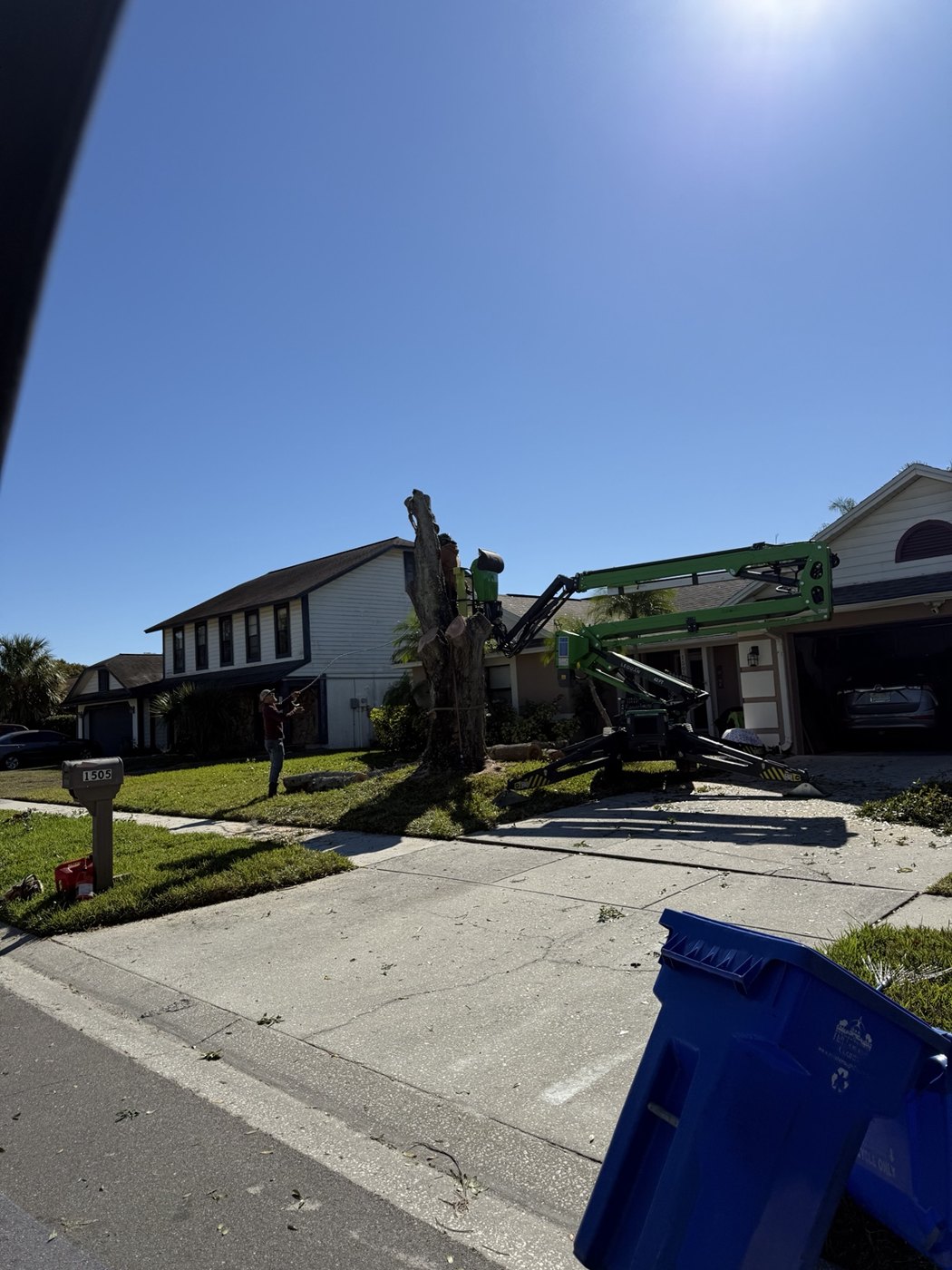 Top Notch crew using a tracked lift for a residential tree removal